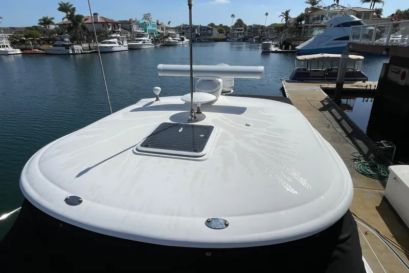 Slide: The Image of 2007 Sea Ray 440 Express yacht docked in a marina, showcasing sleek deck design. - 9