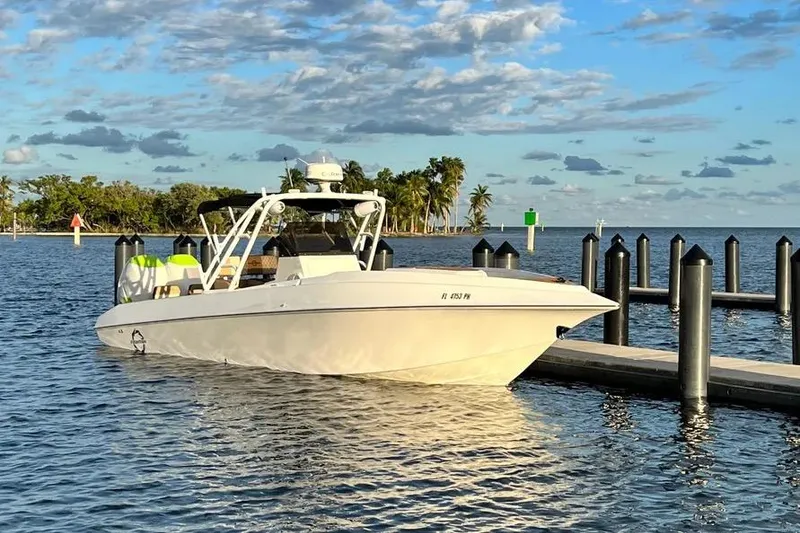 The Image of 1993 Fountain 31 Tournament Edition boat docked on calm water under a blue sky. - 1