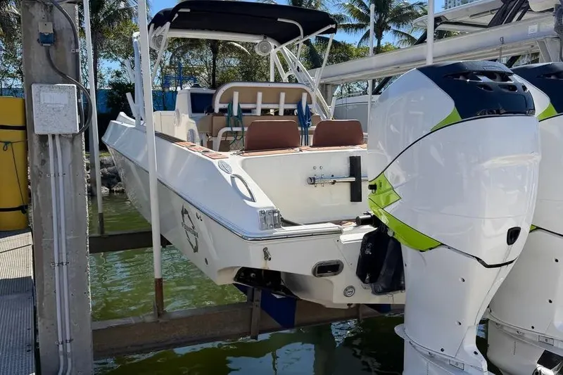 Slide: The Image of 1993 Fountain 31 Tournament Edition boat with dual outboard motors, docked near palm trees. - 11