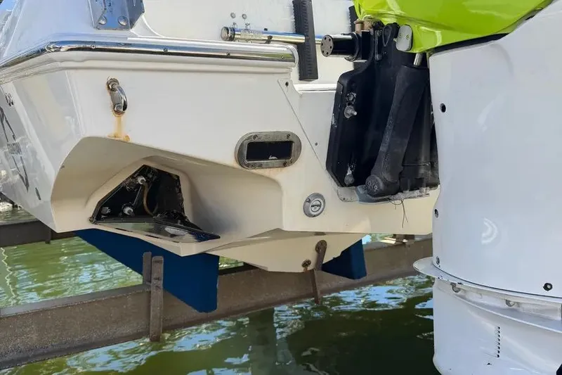 Slide: The Image of 1993 Fountain 31 Tournament Edition boat stern with outboard motor on a lift. - 12