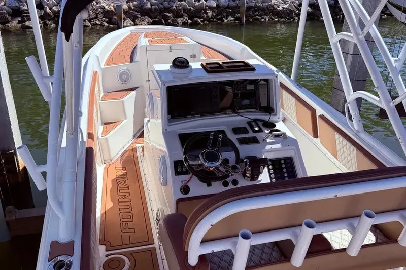 Slide: The Image of 1993 Fountain 31 Tournament Edition boat interior with steering console and seating. - 14