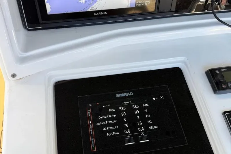 Slide: The Image of Simrad and Garmin displays on 1993 Fountain 31 Tournament Edition boat dashboard. - 4