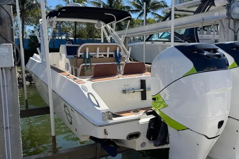 Slide: The Image of 1993 Fountain 31 Tournament Edition boat with dual outboard motors docked near palm trees. - 9