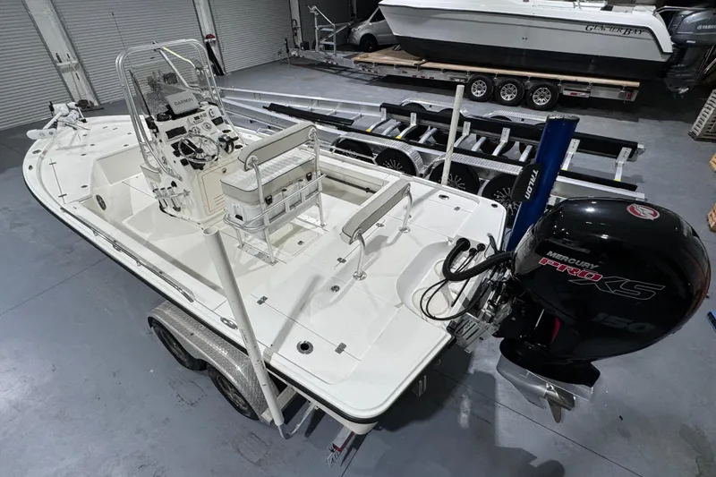 Slide: The Image of 2017 Mako 21 LTS boat with Mercury Pro XS 150 engine in a garage setting. - 16