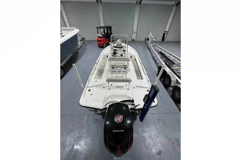 Slide: The Image of 2017 Mako 21 LTS boat with Mercury engine in a showroom. - 19