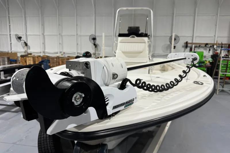 Slide: The Image of 2017 Mako 21 LTS boat with trolling motor in a spacious indoor setting. - 20