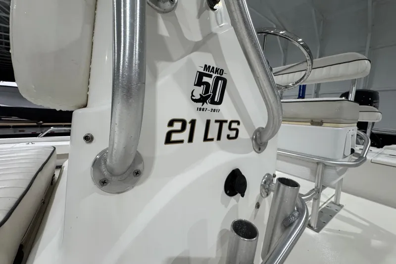 Slide: The Image of 2017 Mako 21 LTS boat interior with anniversary logo and seating details. - 21