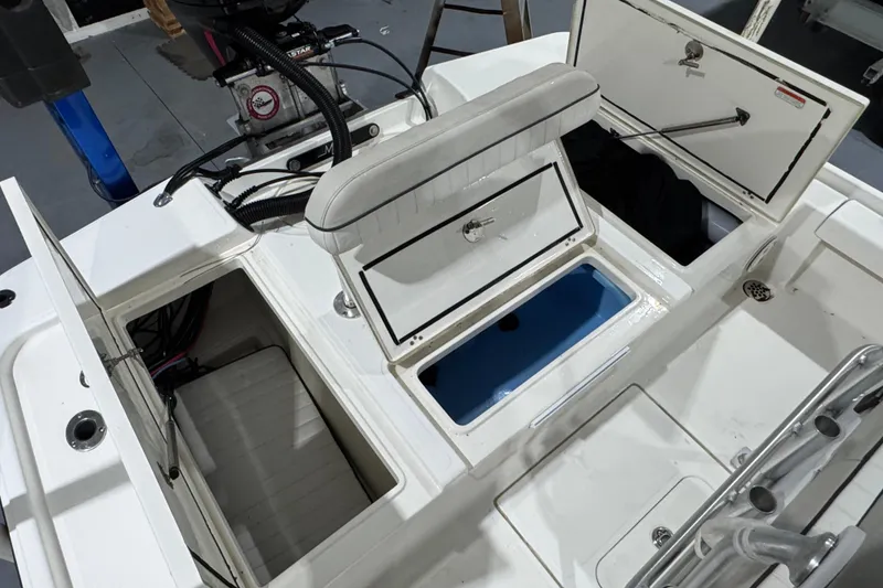 Slide: The Image of 2017 Mako 21 LTS boat interior with open storage compartments and seating. - 22