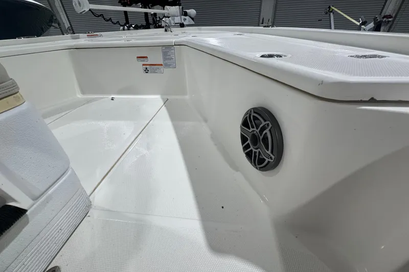 Slide: The Image of Interior view of a 2017 Mako 21 LTS boat, featuring a speaker and clean deck. - 25