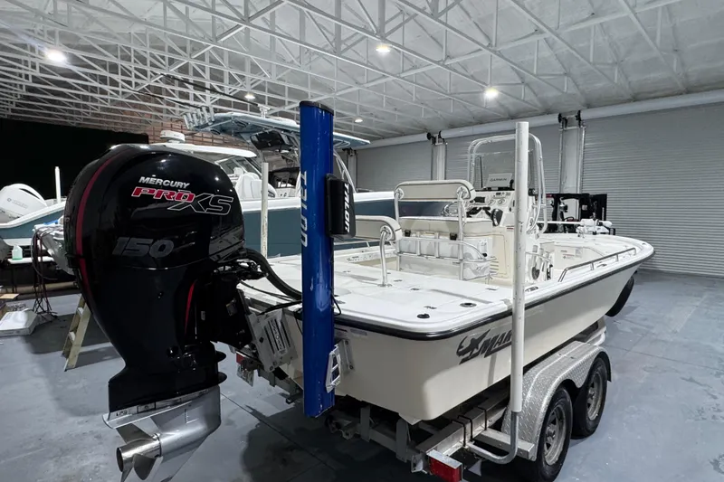 Slide: The Image of 2017 Mako 21 LTS boat with Mercury Pro XS engine in a spacious indoor setting. - 3