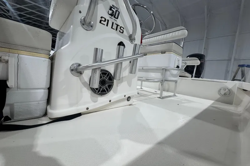 Slide: The Image of 2017 Mako 21 LTS boat interior with steering console and seating. - 31