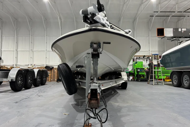 Slide: The Image of 2017 Mako 21 LTS boat on trailer in a spacious indoor garage. - 6