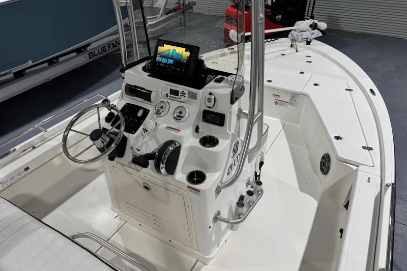 Slide: The Image of 2017 Mako 21 LTS boat interior with steering console and navigation equipment. - 8
