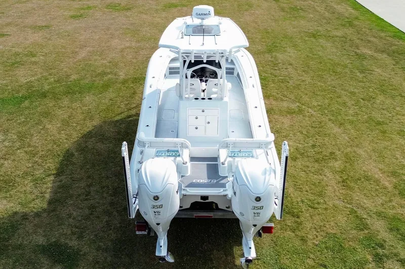 Slide: The Image of 2022 Costa Custom Boats 264 HC on grass, featuring dual 350 V6 engines. - 11