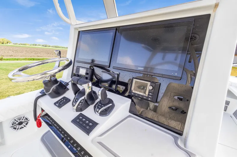 Slide: The Image of Helm of 2022 Costa Custom Boats 264 HC with advanced navigation displays and controls. - 13