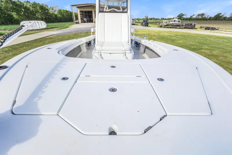 Slide: The Image of 2022 Costa Custom Boats 264 HC, spacious deck view, white finish, outdoor setting. - 18