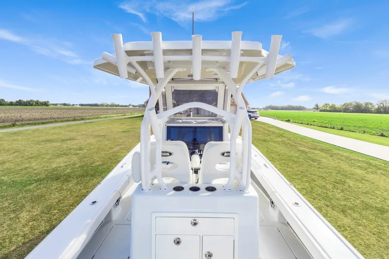 Slide: The Image of 2022 Costa Custom Boats 264 HC on grassy field under clear blue sky. - 19