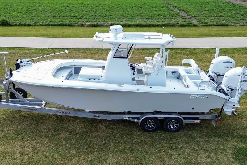 Slide: The Image of 2022 Costa Custom Boats 264 HC on trailer, parked on grass, side view. - 5