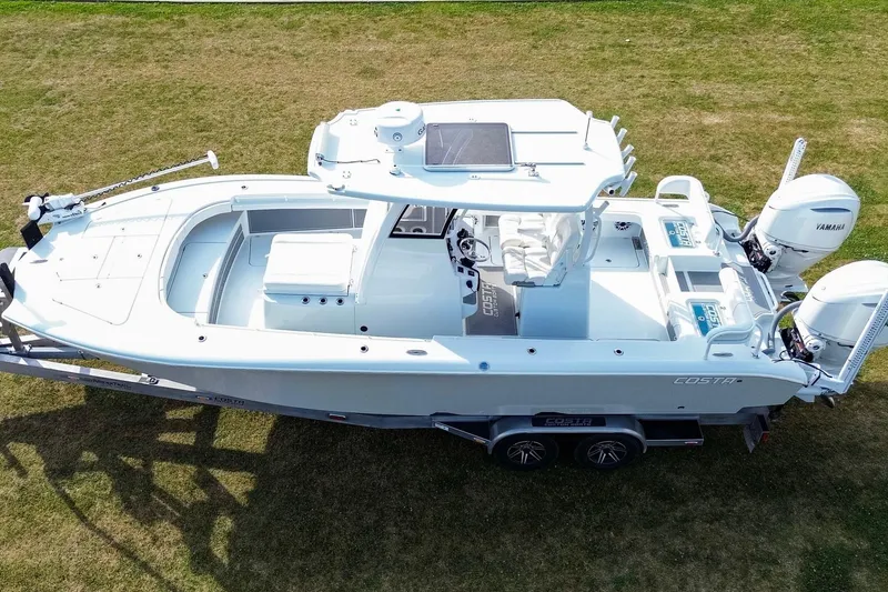 Slide: The Image of 2022 Costa Custom Boats 264 HC on trailer, aerial view, parked on grass. - 9