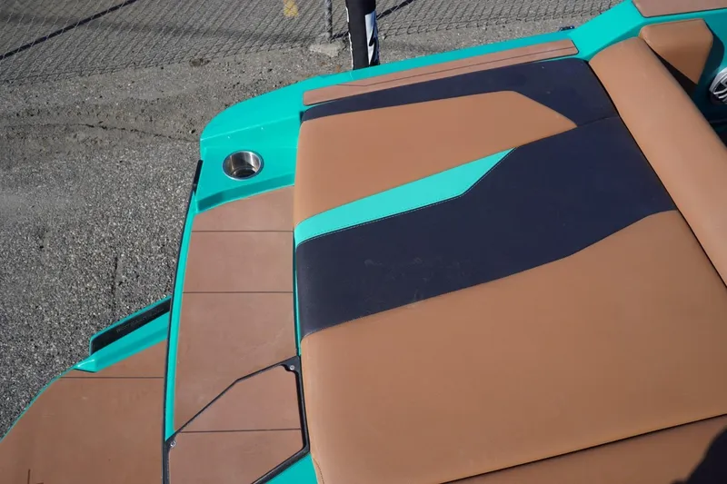 Slide: The Image of 2023 Axis T235 boat with brown and teal seating, cup holder visible. - 12