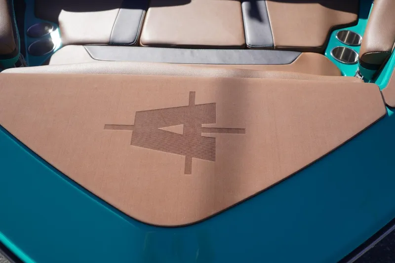 Slide: The Image of 2023 Axis T235 boat interior with tan upholstery and cup holders. - 15