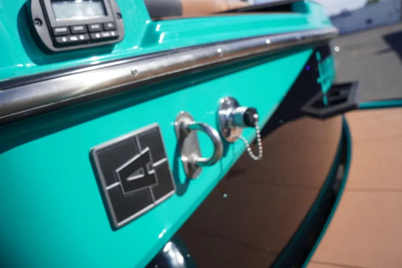 Slide: The Image of 2023 Axis T235 boat detail with teal exterior and control panel. - 18