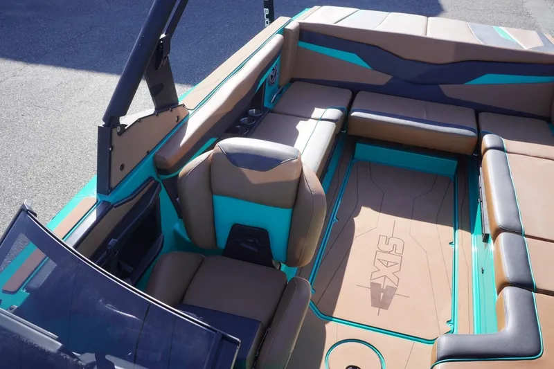 Slide: The Image of 2023 Axis T235 boat interior with teal and brown seating, showcasing modern design. - 26