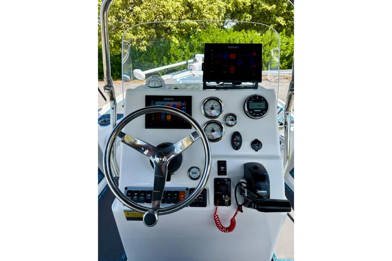 Slide: The Image of 2023 Key West 188 Bay Reef boat dashboard with steering wheel and navigation instruments. - 19