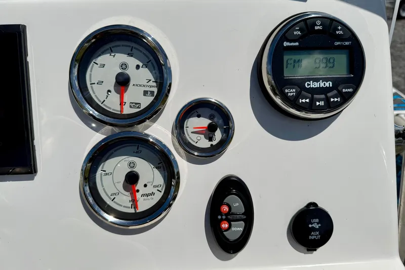 Slide: The Image of Dashboard of 2023 Key West 188 Bay Reef boat with gauges and Clarion radio. - 21
