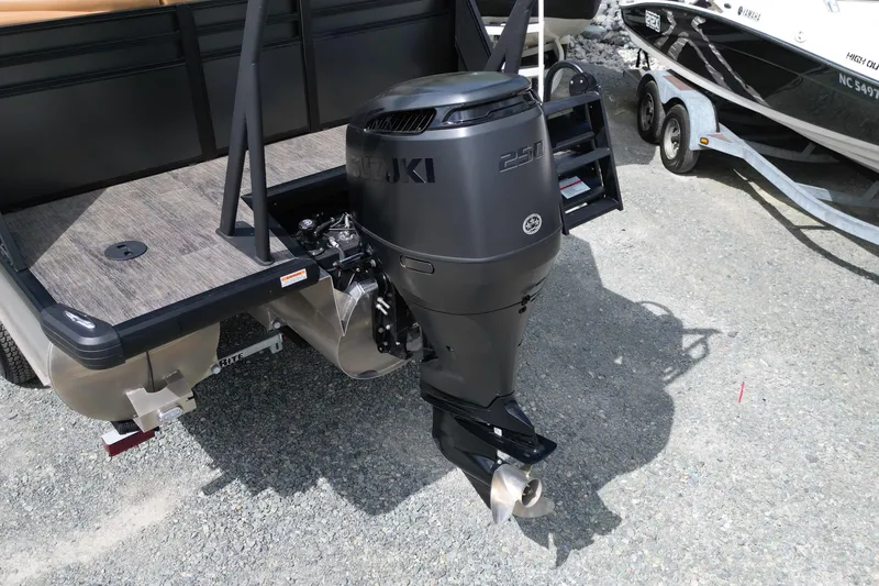 Slide: The Image of 2025 Viaggio Lago X-U 24 boat with Suzuki 250 outboard motor, parked on gravel. - 11