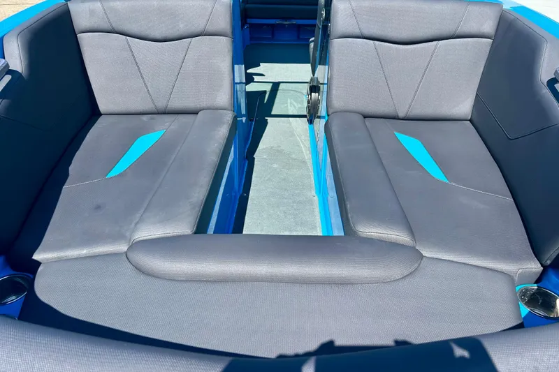 Slide: The Image of Interior seating of a 2021 MasterCraft NXT24 boat with gray and blue upholstery. - 11