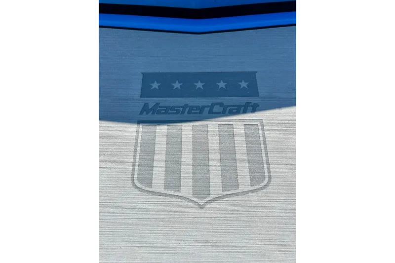 Slide: The Image of 2021 MasterCraft NXT24 logo with stars and stripes design on boat surface. - 16