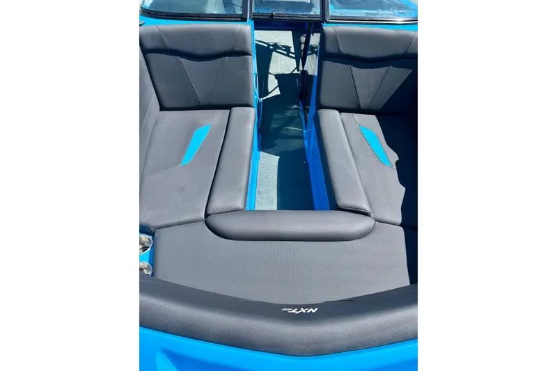 Slide: The Image of 2021 MasterCraft NXT24 boat interior with sleek gray and blue seating design. - 18