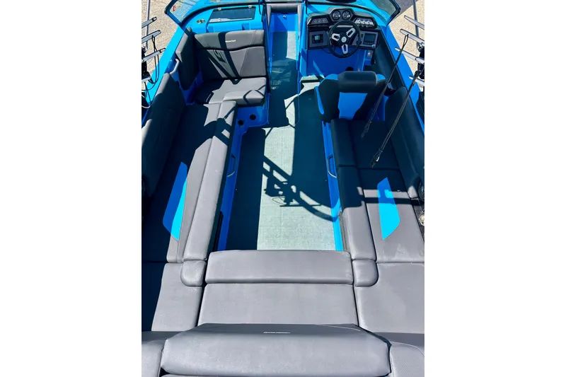 Slide: The Image of 2021 MasterCraft NXT24 boat interior with blue and gray seating and modern dashboard. - 20
