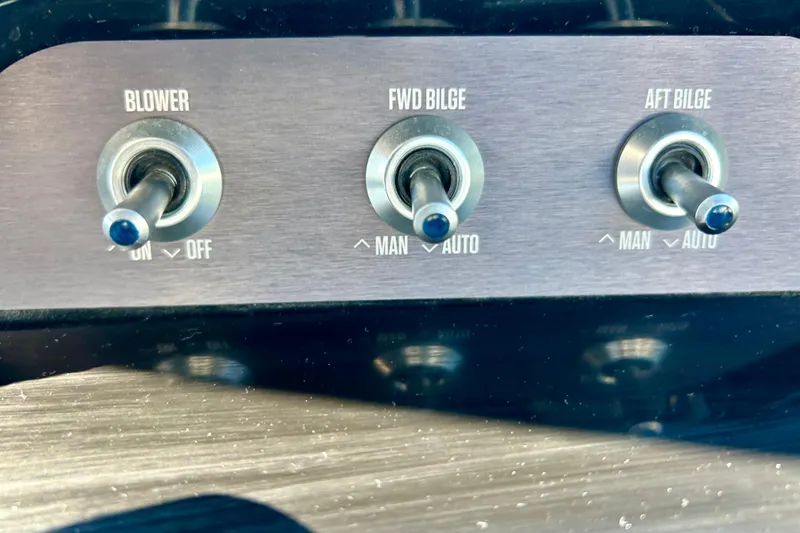 Slide: The Image of Control panel of a 2021 MasterCraft NXT24 boat with blower and bilge switches. - 30