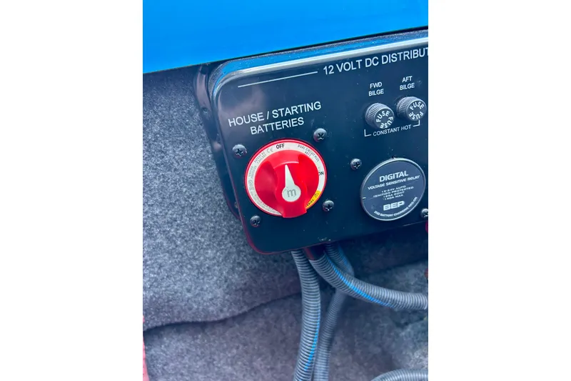 Slide: The Image of Control panel of a 2021 MasterCraft NXT24 boat, featuring battery switches and voltage relay. - 39