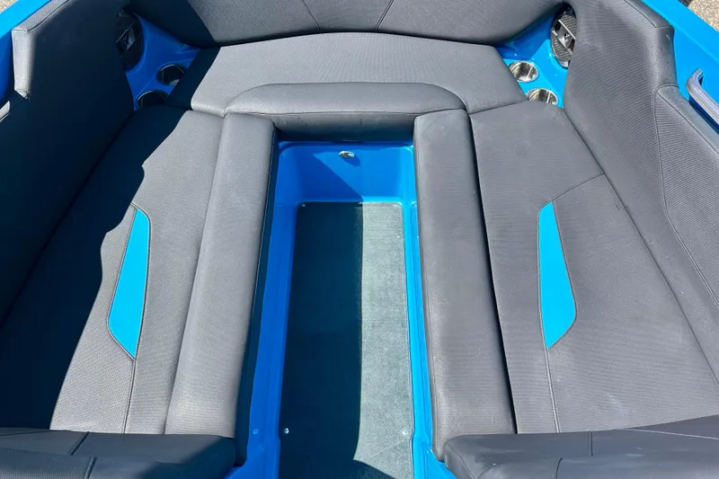 Slide: The Image of Interior seating of a 2021 MasterCraft NXT24 boat, featuring blue and gray upholstery. - 43