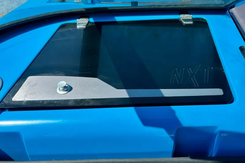 Slide: The Image of Blue 2021 MasterCraft NXT24 boat detail with NXT logo on hatch. - 51