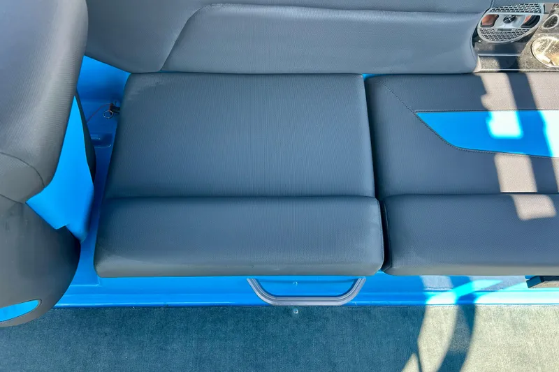 Slide: The Image of 2021 MasterCraft NXT24 boat interior seating with blue and black upholstery. - 55