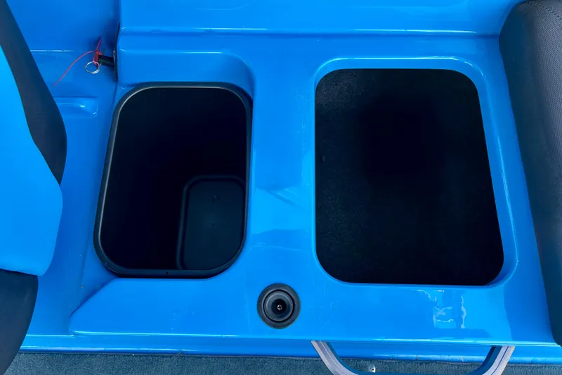 Slide: The Image of 2021 MasterCraft NXT24 boat storage compartments in vibrant blue interior. - 56