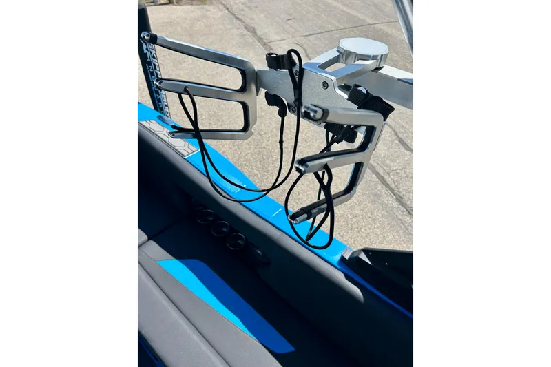 Slide: The Image of 2021 MasterCraft NXT24 boat with wakeboard rack and blue interior detail. - 60