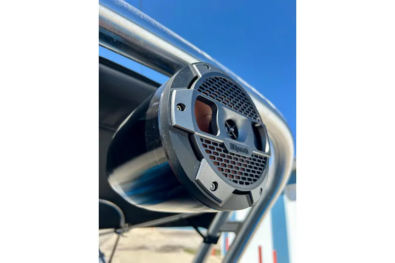 Slide: The Image of Close-up of a speaker on a 2021 MasterCraft NXT24 boat against a clear blue sky. - 61