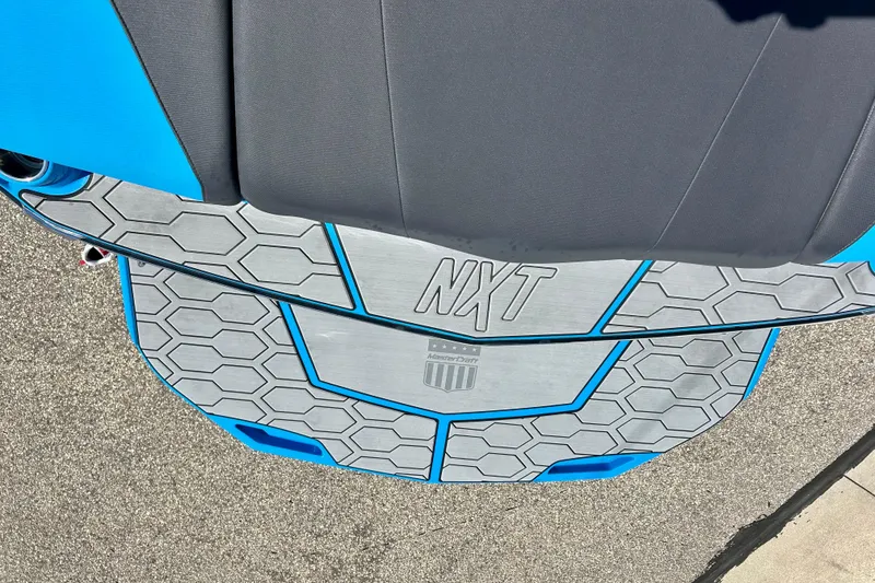 Slide: The Image of 2021 MasterCraft NXT24 boat deck with hexagonal pattern and blue accents. - 63