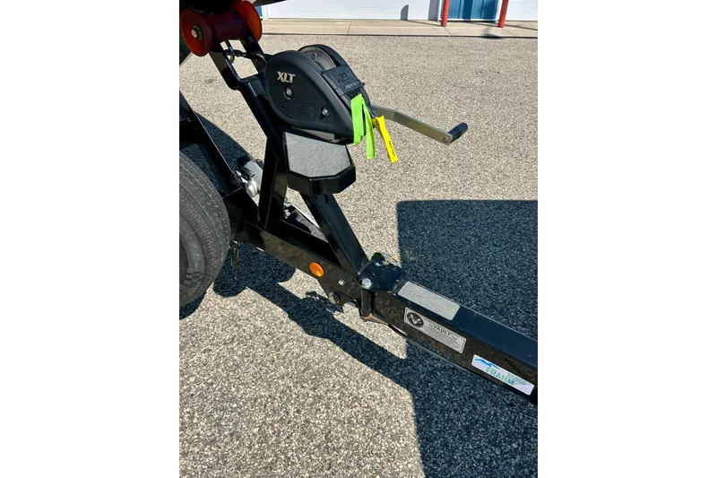 Slide: The Image of Trailer hitch of a 2021 MasterCraft NXT24 boat on pavement. - 68