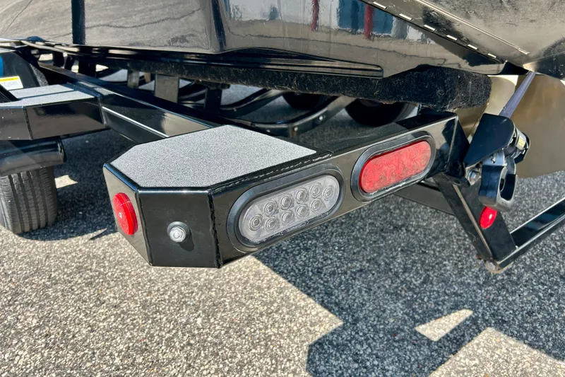 Slide: The Image of Trailer lights and hitch of a 2021 MasterCraft NXT24 boat on asphalt. - 69