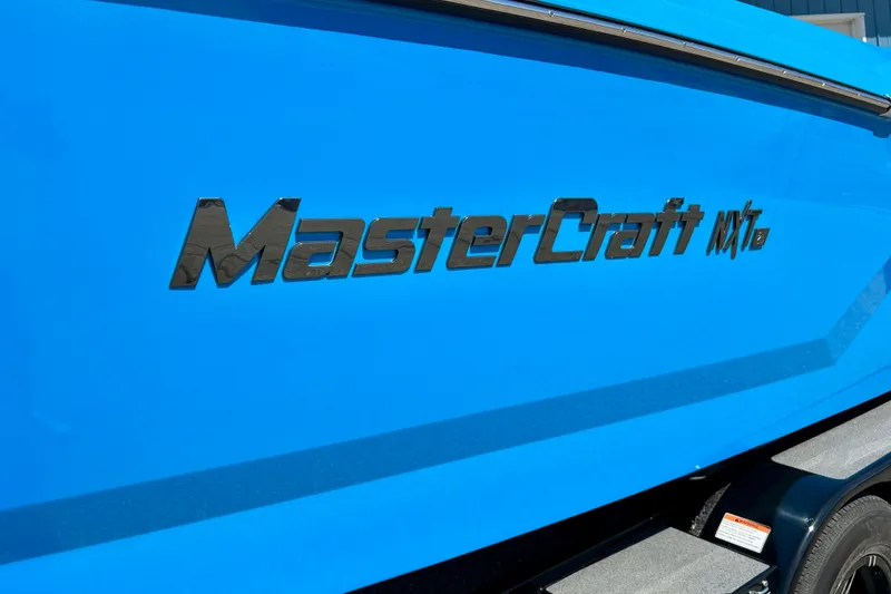 Slide: The Image of Blue 2021 MasterCraft NXT24 boat with logo on the side. - 7