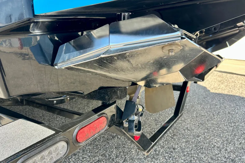 Slide: The Image of 2021 MasterCraft NXT24 boat trailer hitch and rear detail on asphalt surface. - 70