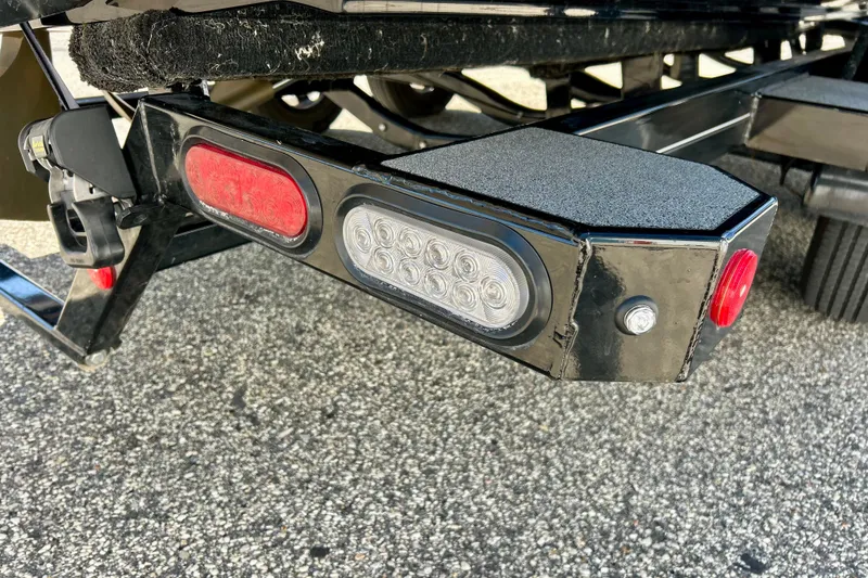 Slide: The Image of Trailer lights on a 2021 MasterCraft NXT24 boat trailer, featuring red and white LED indicators. - 72