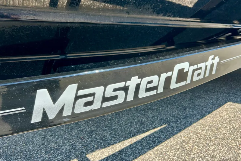 Slide: The Image of Close-up of 2021 MasterCraft NXT24 logo on a sleek black surface. - 73