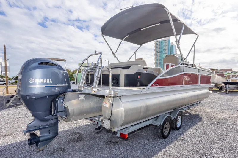 Slide: The Image of 2021 Barletta C24UC pontoon boat with Yamaha outboard motor on trailer. - 10